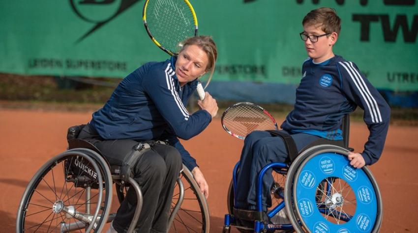 Twee personen spelen rolstoeltennis